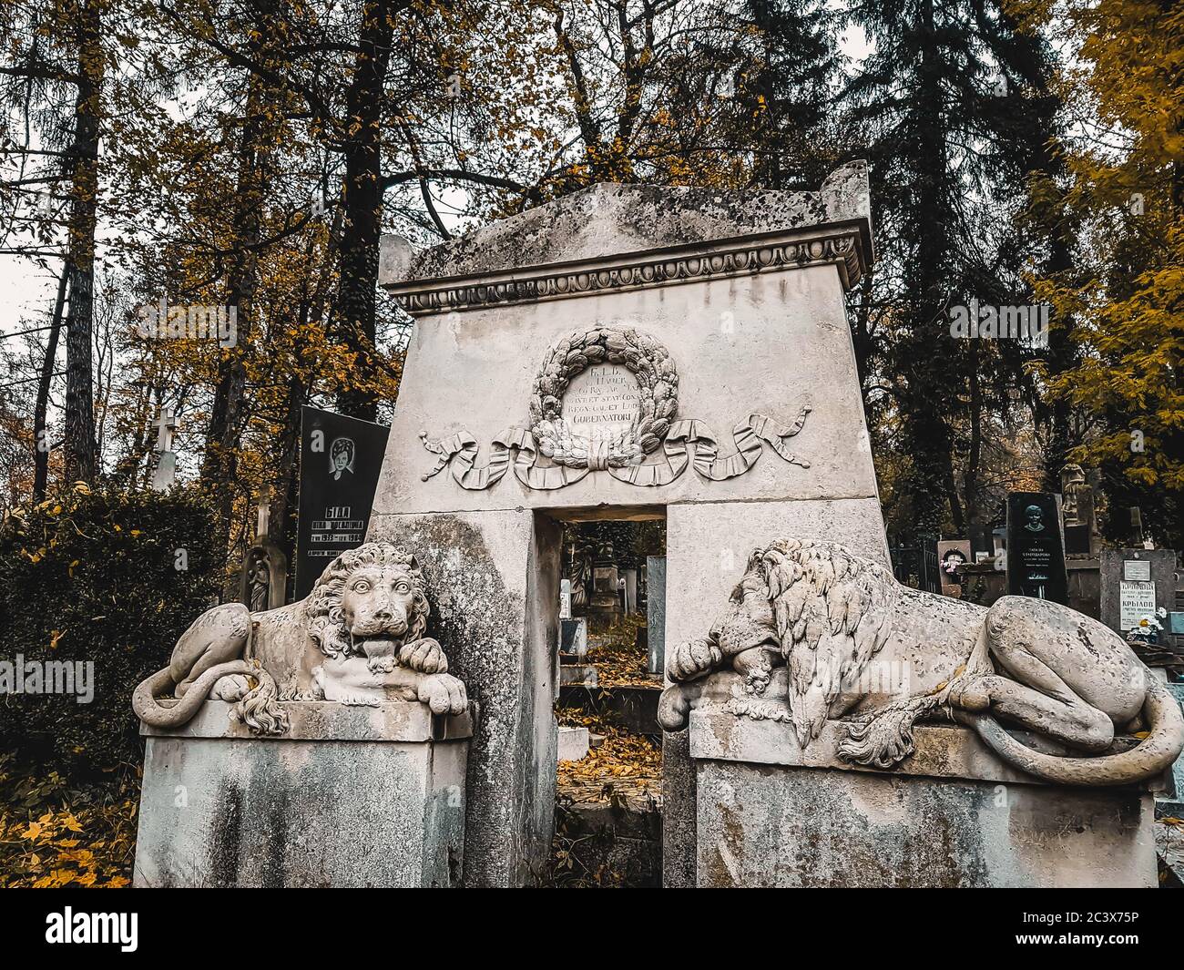Lviv / Ukraine - November 2019: Tombstone and lion sculptures in a crypt outdoor at Lychakiv cemetery. Famous old graveyard in eastern Europe. Stock Photo