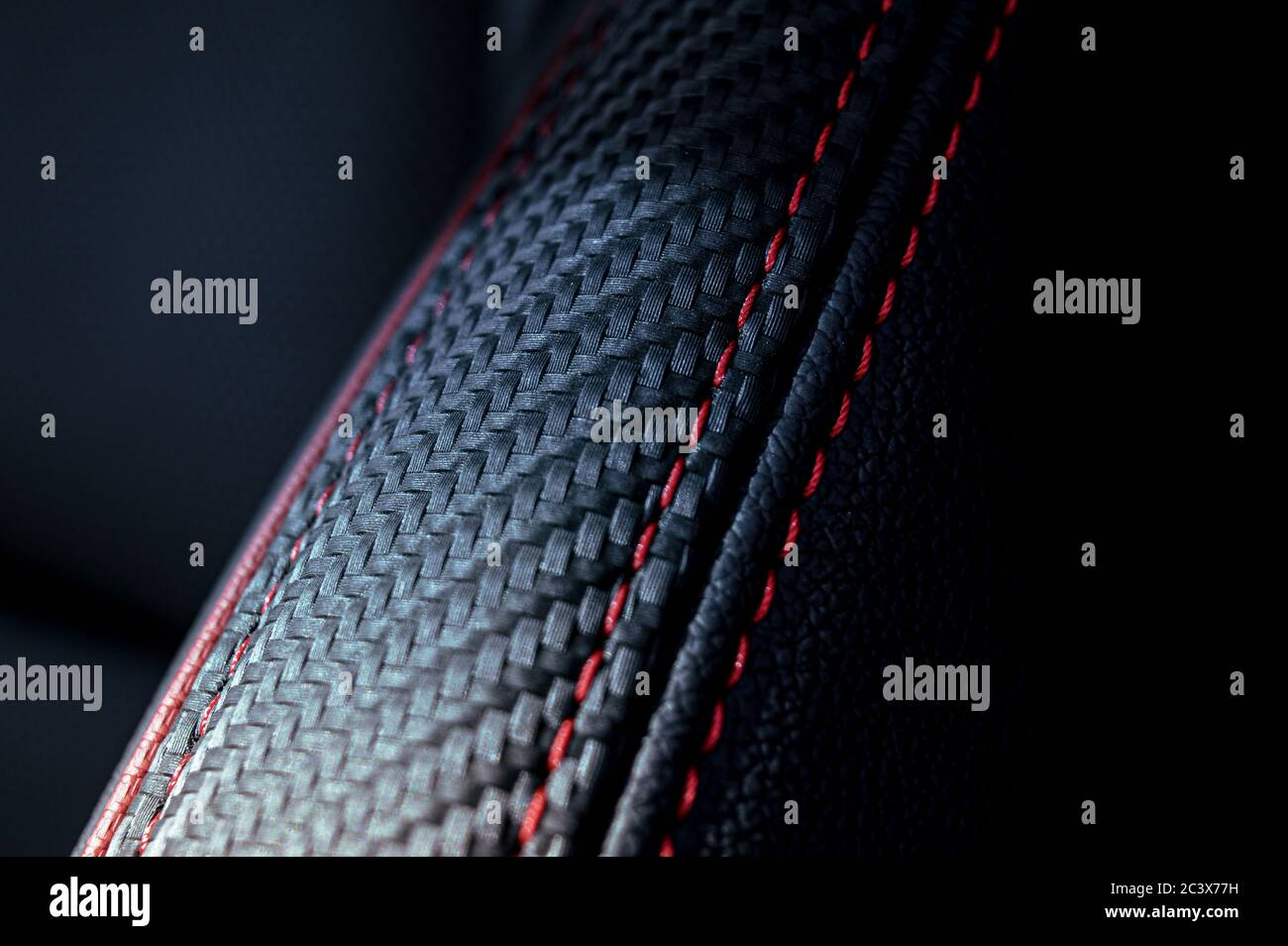 Luxury vehicles interior leather red stitching. Stock Photo
