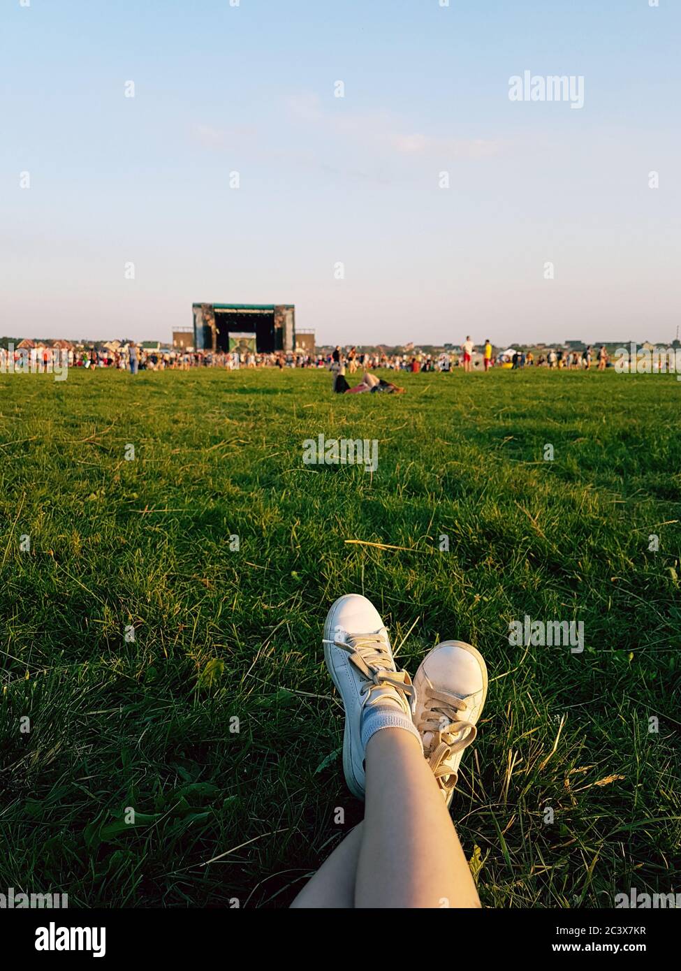 Relaxing at open air music festival in Ukraine. Traditional celebration with famous music groups performing on stage. Listening to live music Stock Photo