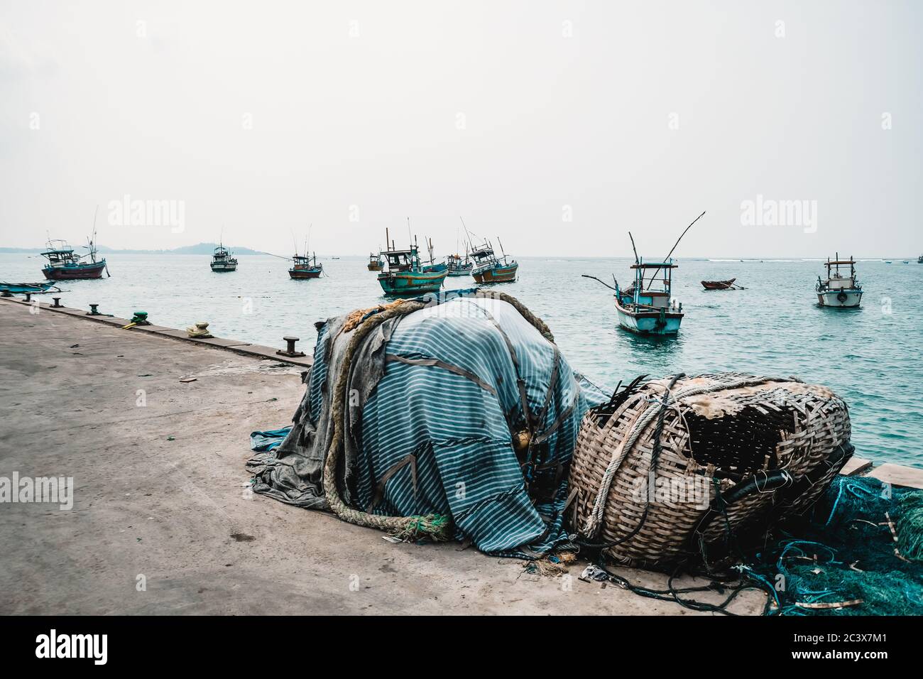 Abandoned fishing gear at a pier. Traditional local craftsmanship in Sri  Lanka. Cold colors and grey sky. Destroyed accessories: fishing net, straw  Stock Photo - Alamy