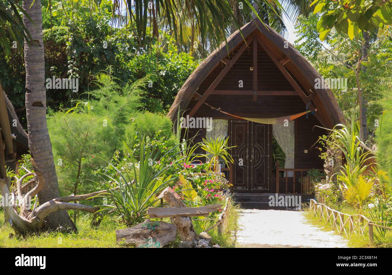 Exotic sasak wooden bungalow in lush garden on Gili Air island, Lombok, Indonesia Stock Photo