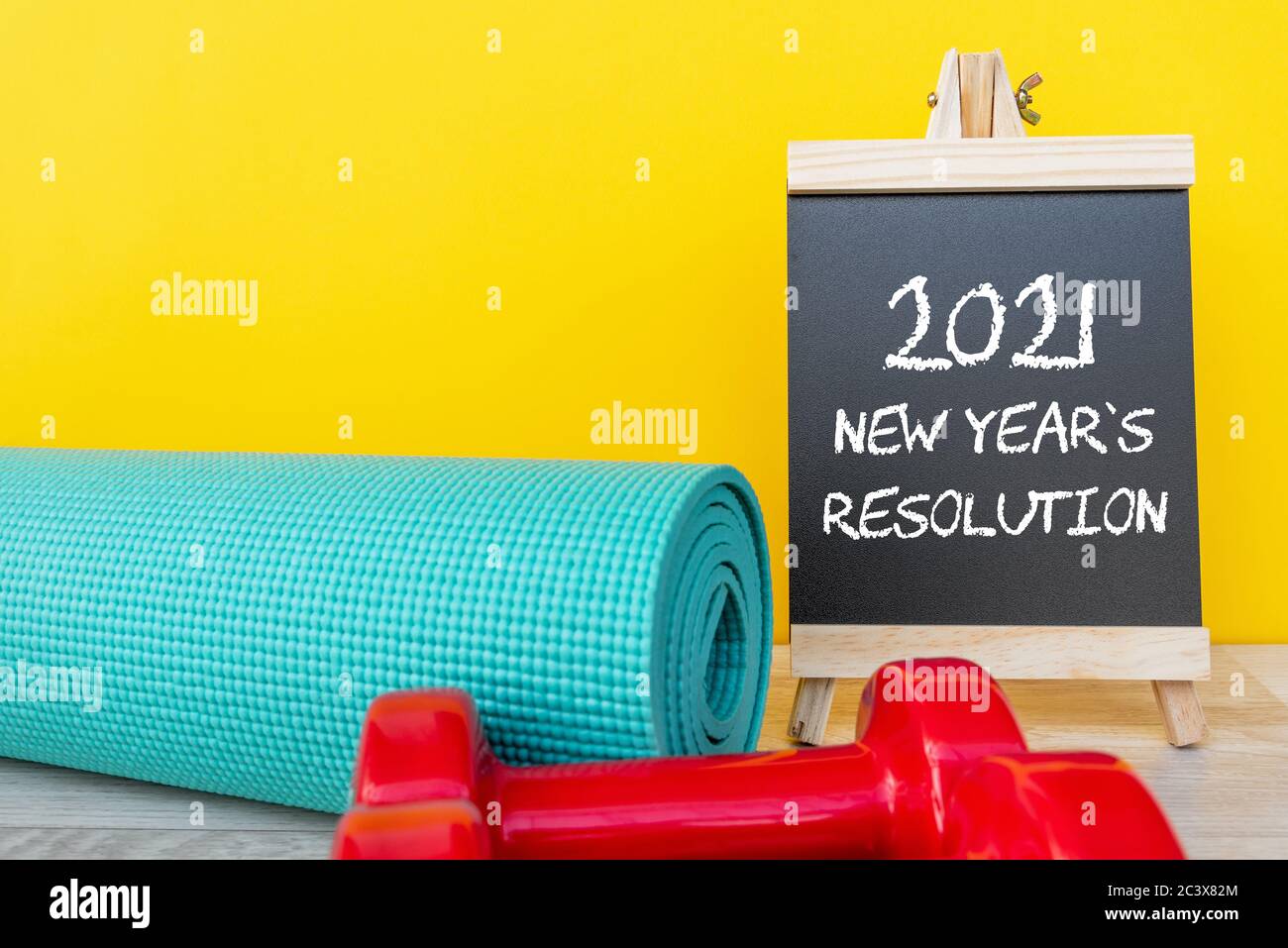2021 New Year's Resolution with yoga mat and dumbbell - fitness concept Stock Photo