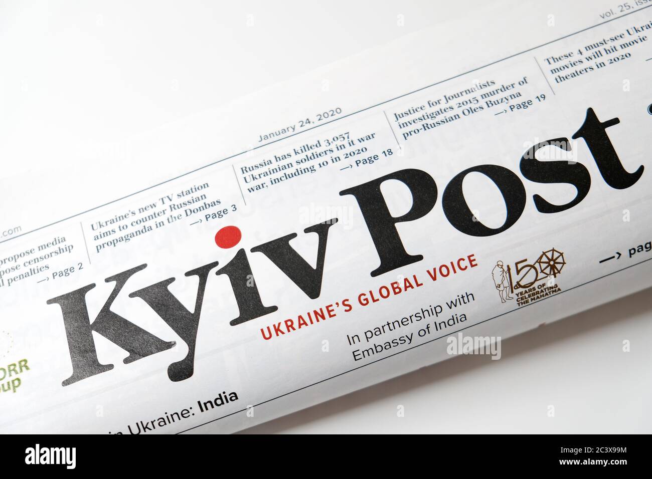 Lviv / Ukraine - March 2020: Close up view of the front page of folded Ukrainian newspaper Kyiv Post on a white desk. Reading and working from home Stock Photo
