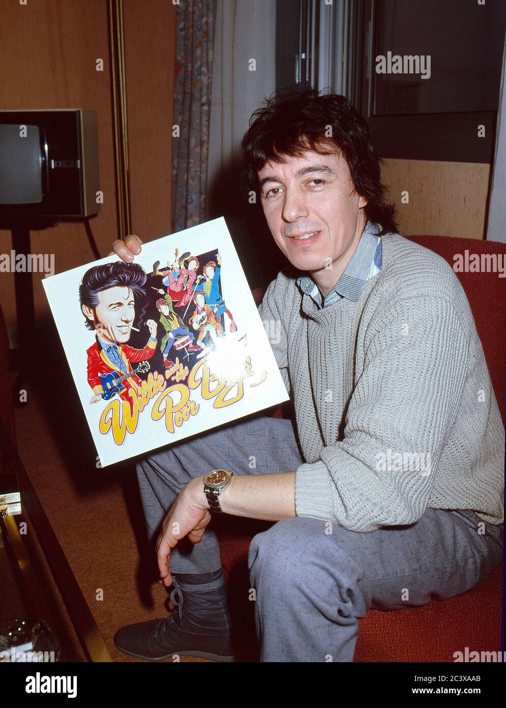 Bill Wyman with the cover of his Willie And The Poor Boys album Stock Photo