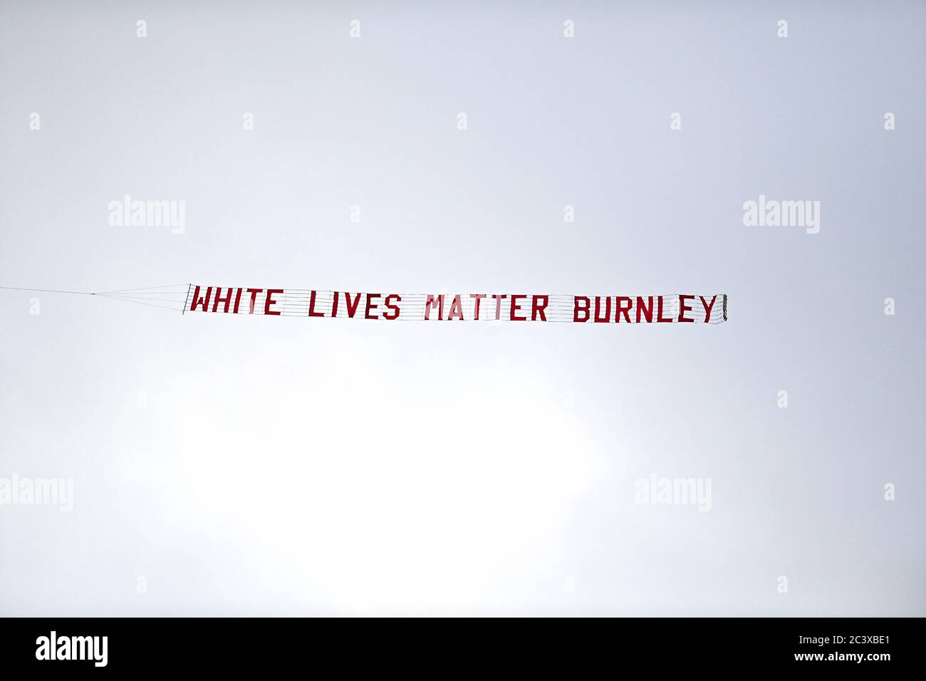 A plane flies over the stadium with a banner reading 'White Lives Matter Burnley' during the Premier League match at the Etihad Stadium, Manchester. Stock Photo