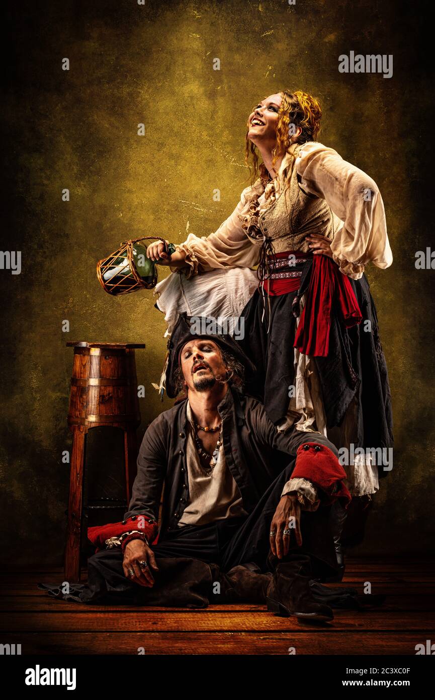 Portrait of a couple of pirates drinking rum in a tavern Stock Photo