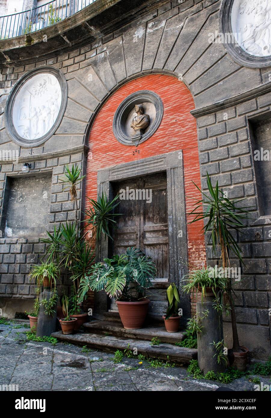 Flowers decorating an Old Italian stone house with an old wooden door ...