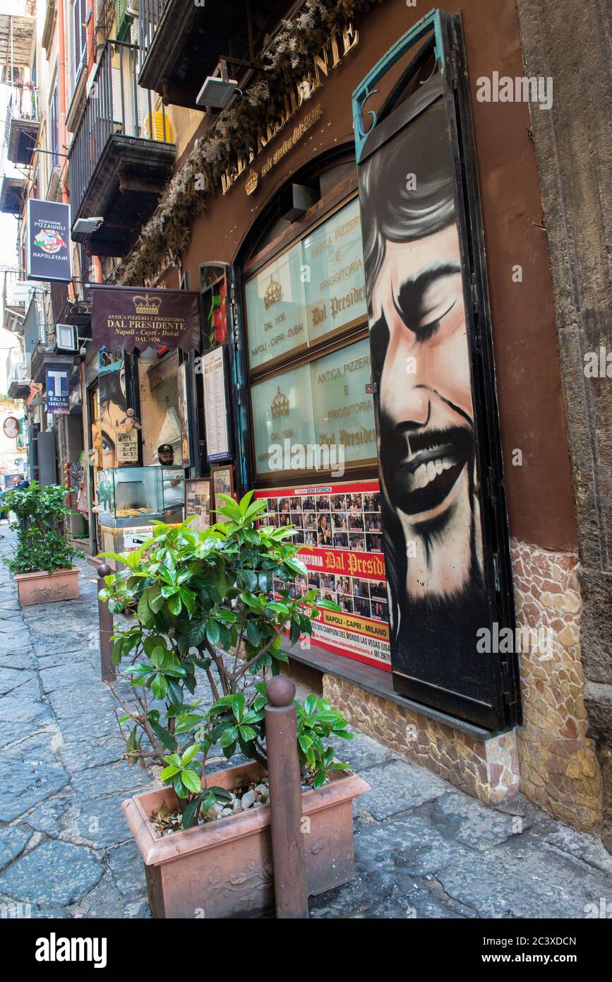 Narrow cobblestone Side Street with sidewalk cafes and souvenir shops
