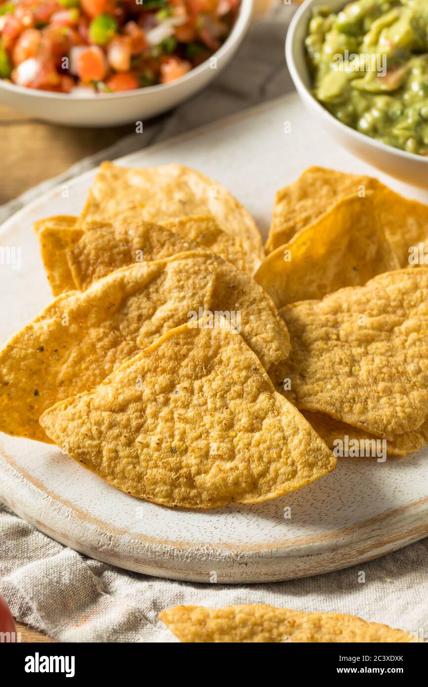 Homemade Tortillas Chips with Salsa and Guacamole with Lime Stock Photo
