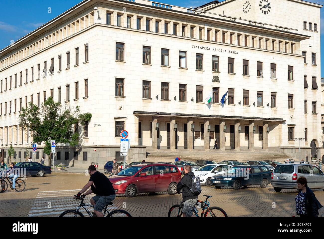 Sofia Bulgaria and the Bulgarian National Bank building headquarters with car traffic and commuters in the streets Eastern Europe Stock Photo