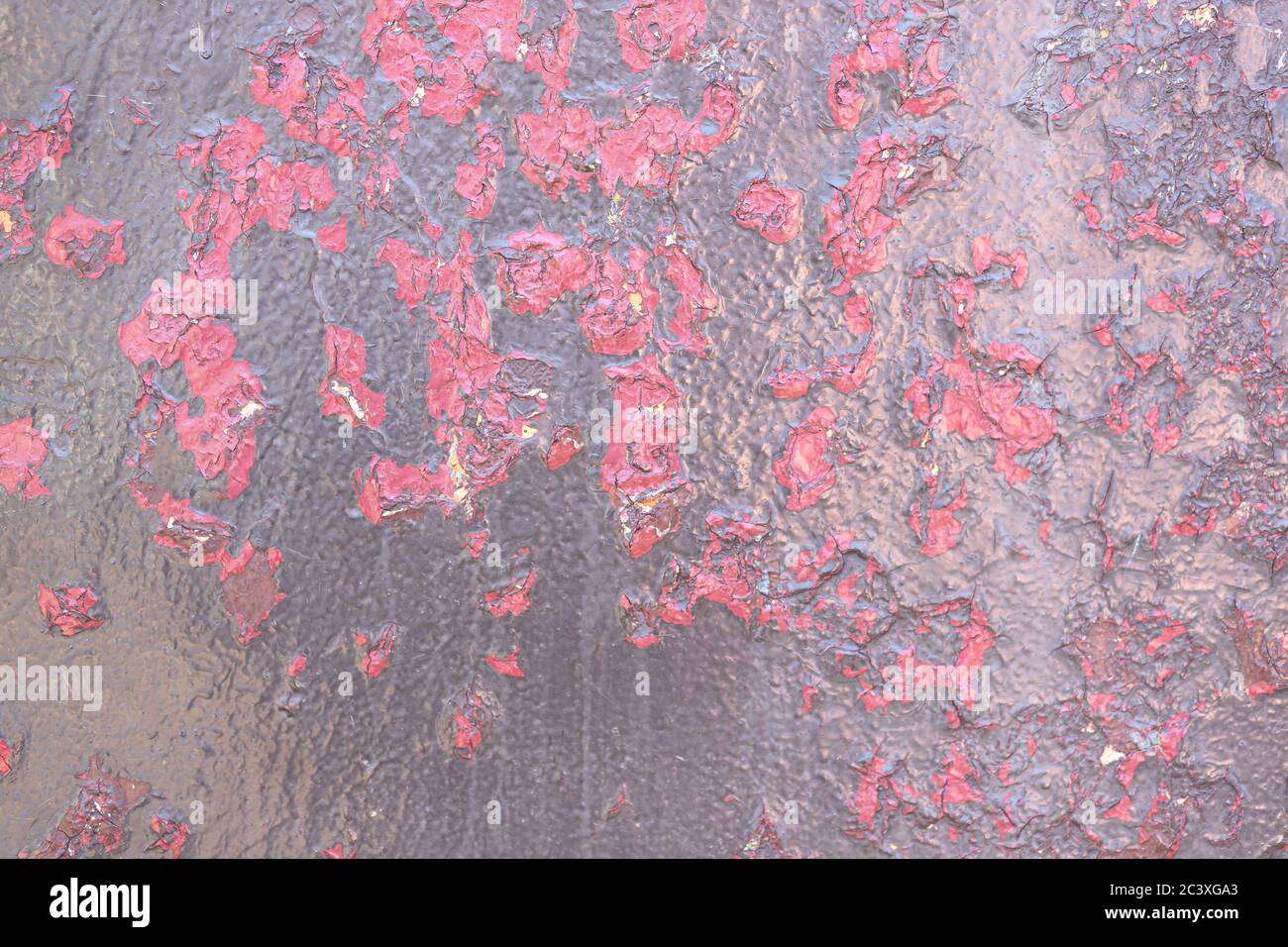Texture of metal surface with flaking brown and raspberry-red paint. Background, close-up Stock Photo