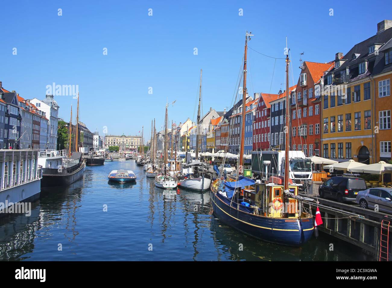 Nyhavn which is a Historic 17th-century waterfront with wooden ships, canal, colourful buildings and entertainment district in Copenhagen, Denmark. Stock Photo