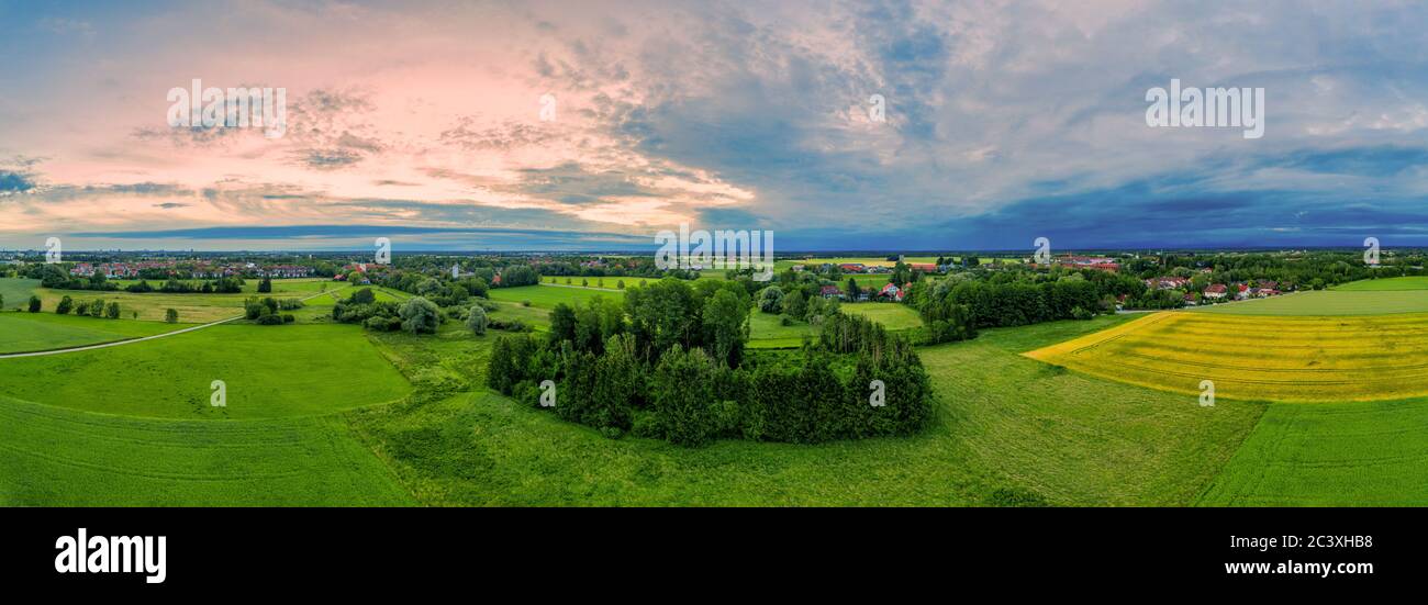 Beautiful panoramic aerial view over a countryside sunrise with fields and trees in southern germany Stock Photo