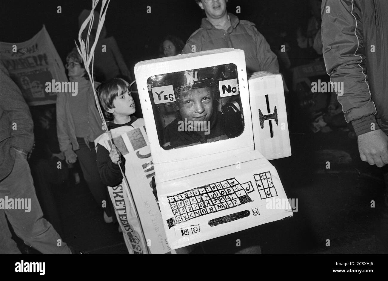 Boy in computer costume at the Greenwich Village Halloween Parade, New York City, USA in the 1980's  Photographed with Black & White film at night. Stock Photo