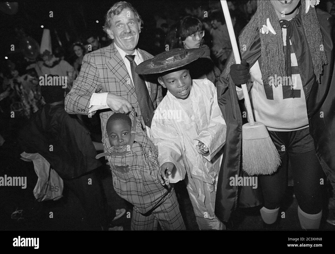 Family at the Greenwich Village Halloween Parade, New York City, USA in the 1980's  Photographed with Black & White film at night. Stock Photo