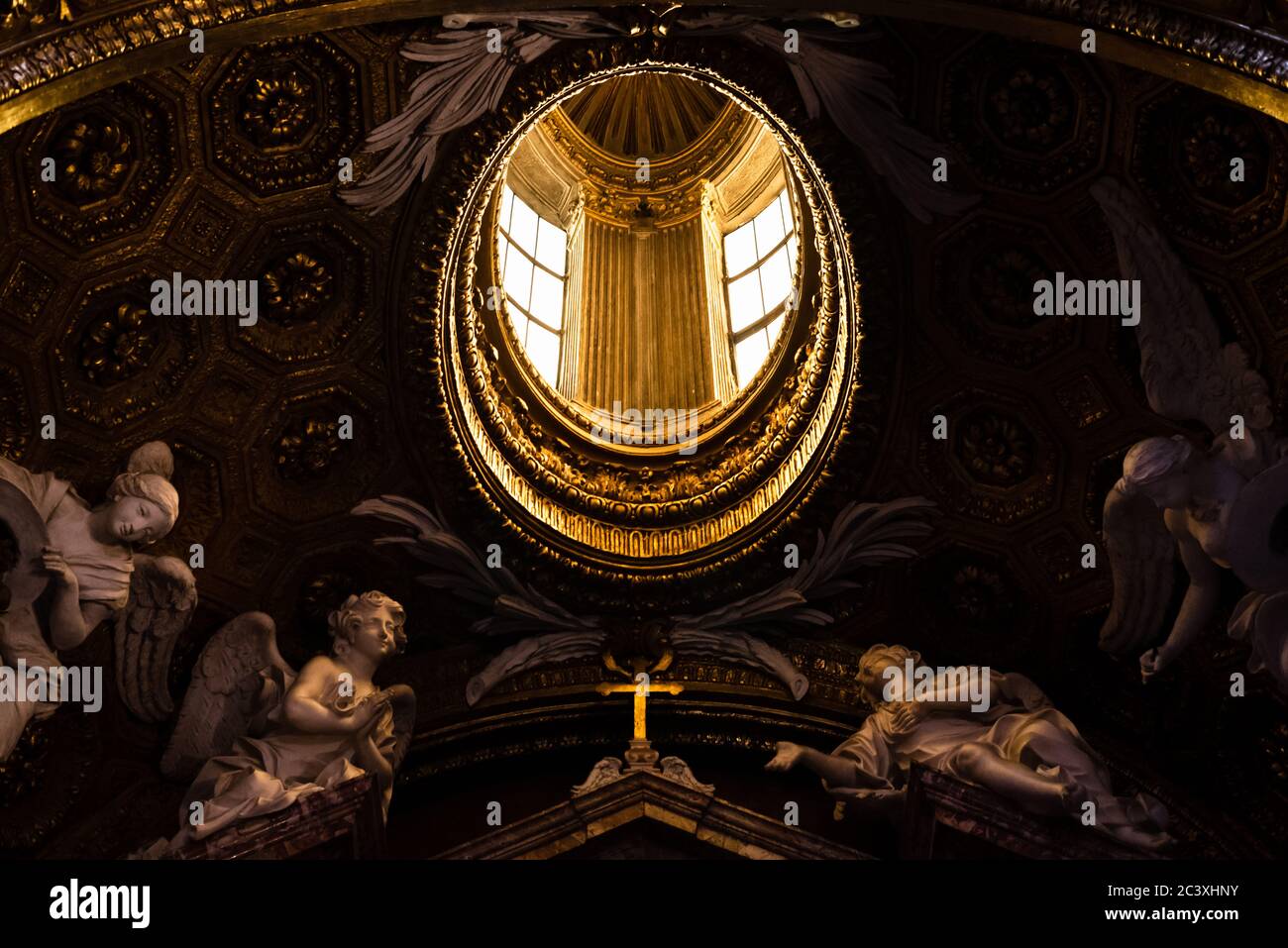 Skylight guarded by statues of angels in a church in Rome, Italy Stock Photo