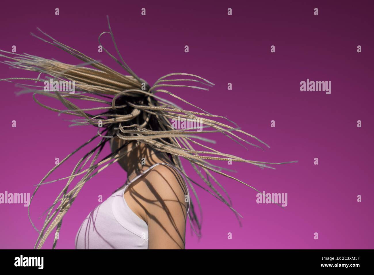 Attractive blonde woman shake head with afro braids Stock Photo