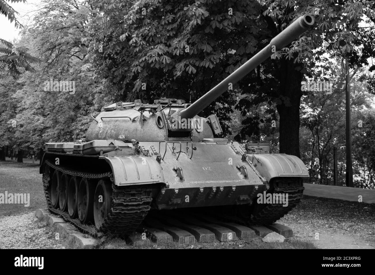 An old tank on display in good condition, photographed in black and