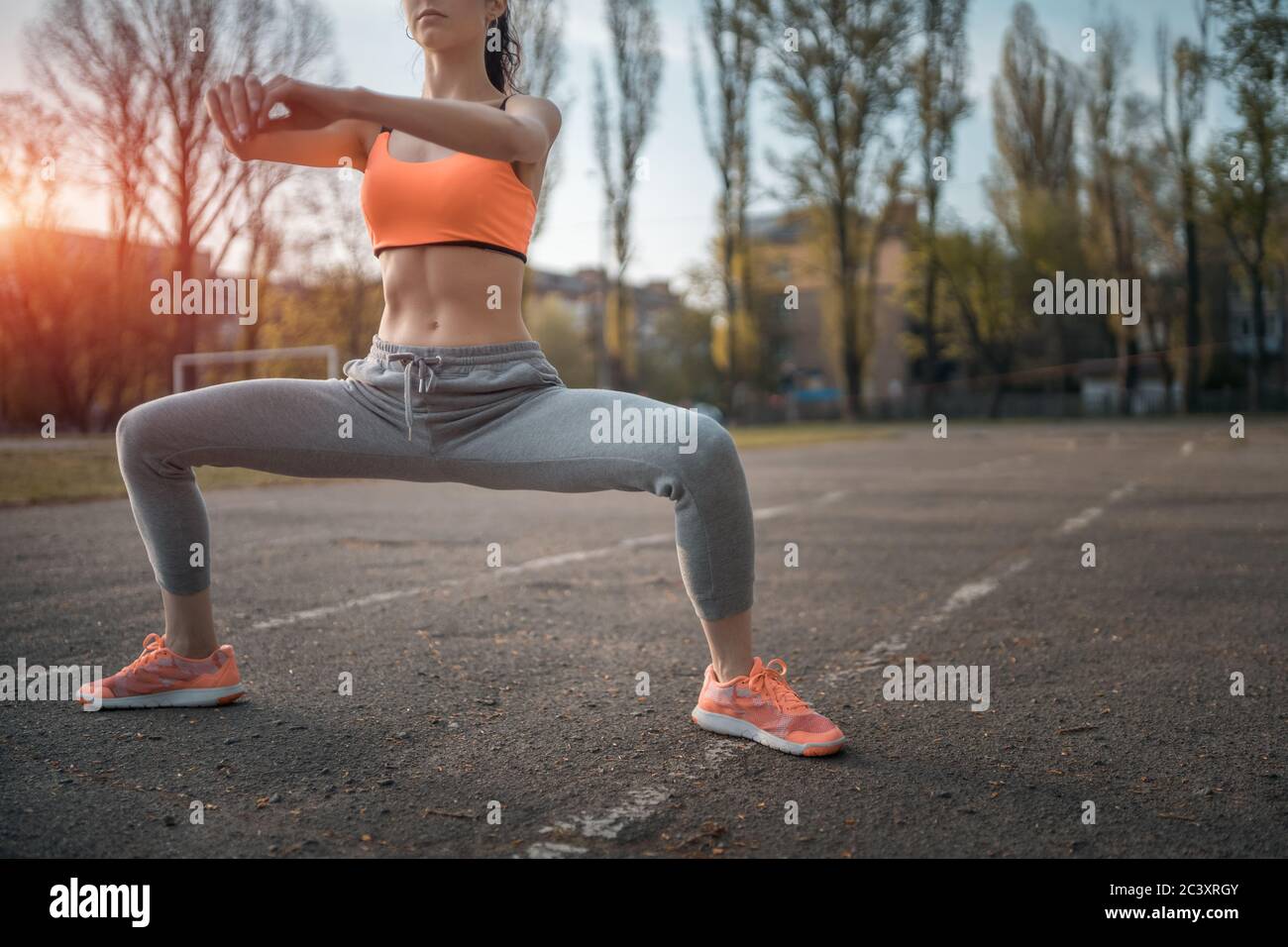 Girls Buttocks In Tight Leggings. Summer Workout On Athletic Track On  Stadium. Skinny Female Sportsman Is Doing Stretching Exercises To Be  Fitted. Stock Photo, Picture and Royalty Free Image. Image 125852145.