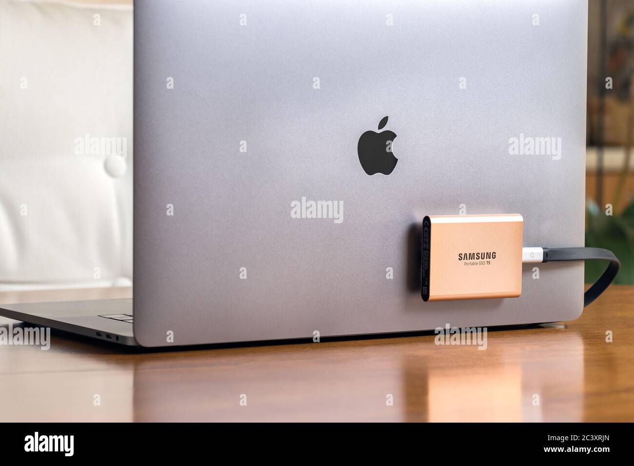 A Samsung T5 Portable SSD hard drive connected to a Macbook Pro laptop  Stock Photo - Alamy