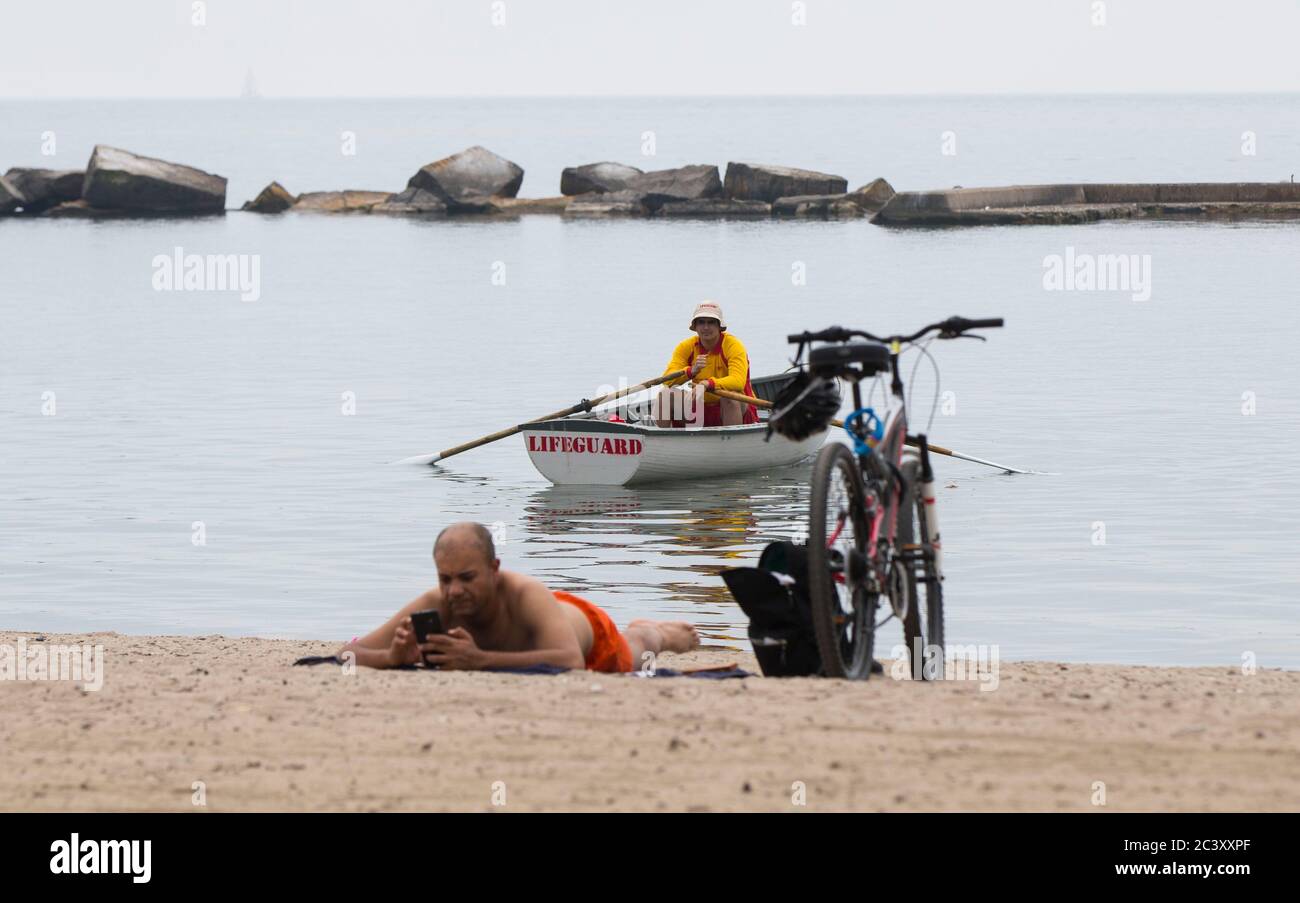 Toronto, Canada. 22nd June, 2020. A lifeguard (Rear) is seen on duty at Sunnyside Beach in Toronto, Canada, on June 22, 2020. Lifeguards returned to six of Toronto's swimming beaches beginning on Monday. Credit: Zou Zheng/Xinhua/Alamy Live News Stock Photo
