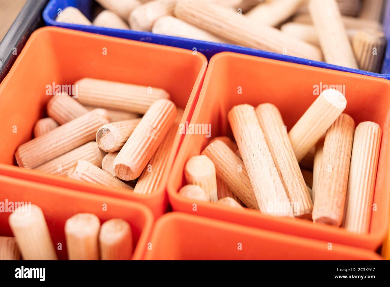 Wooden dowels used in carpentry. Utensils in a box for joining wood