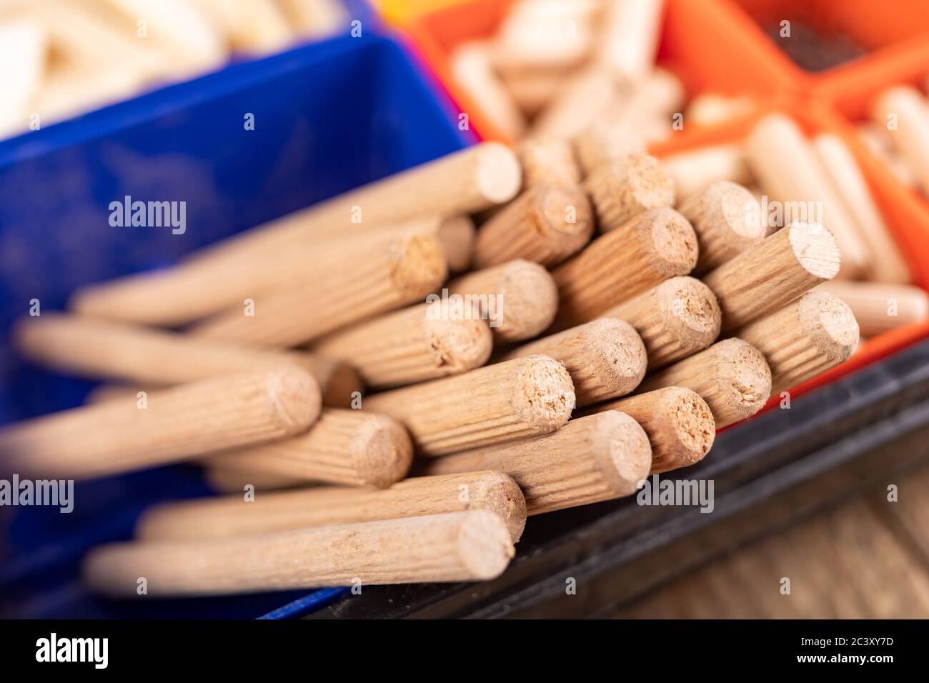 Wooden dowels used in carpentry. Utensils in a box for joining wood