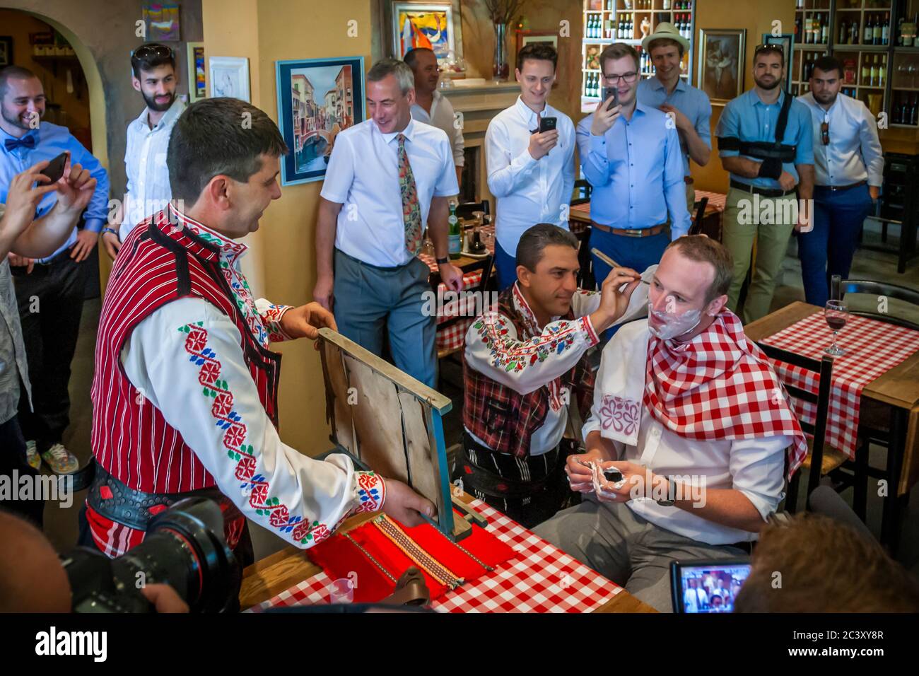 At the beginning of a Bulgarian Wedding the groom is publicly shaved Stock Photo