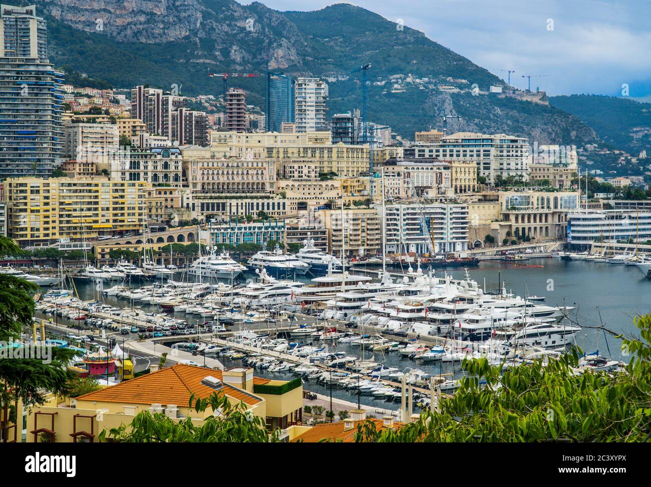 view of Monte Carlo and Port Hercules with moored luxury yachts, Principality of Monaco, French Riviera Stock Photo