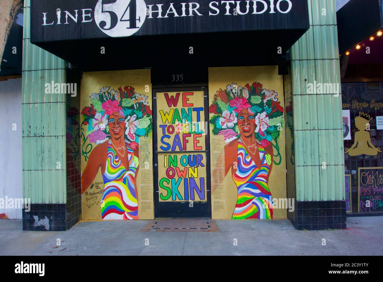Black Lives Matter and transgender street art on boarded up buildings after the killing of George Floyd and subsequent looting of Downtown Oakland. Stock Photo
