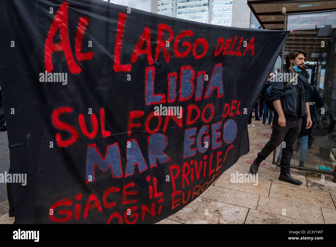 Banner 'Off the coast of Libya on the bottom of the Aegean sea lies the privilege of every European' during the protest assembly in solidarity to BLM. Stock Photo