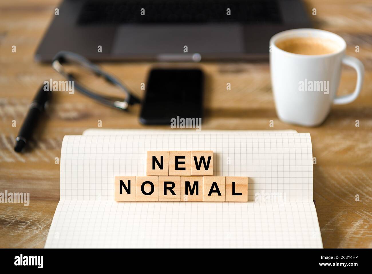 Closeup on notebook over wood table background, focus on wooden blocks ...