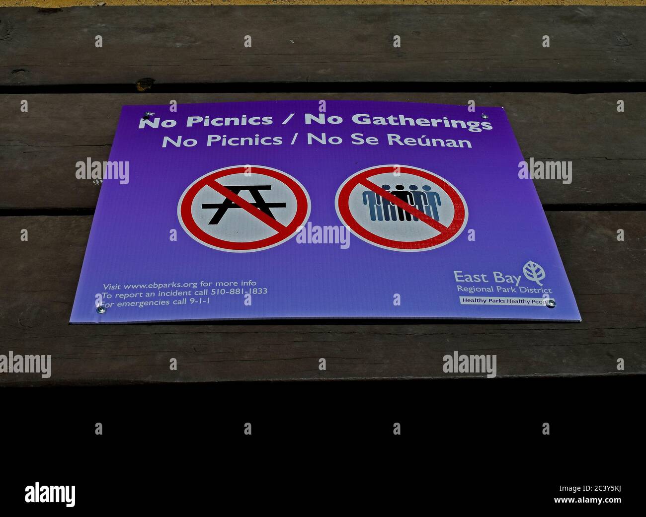 covid-19 virus pandemic sign on a picnic table prohibiting picnics and gatherings at the Alameda Creek Trail Stables Staging Area, California Stock Photo