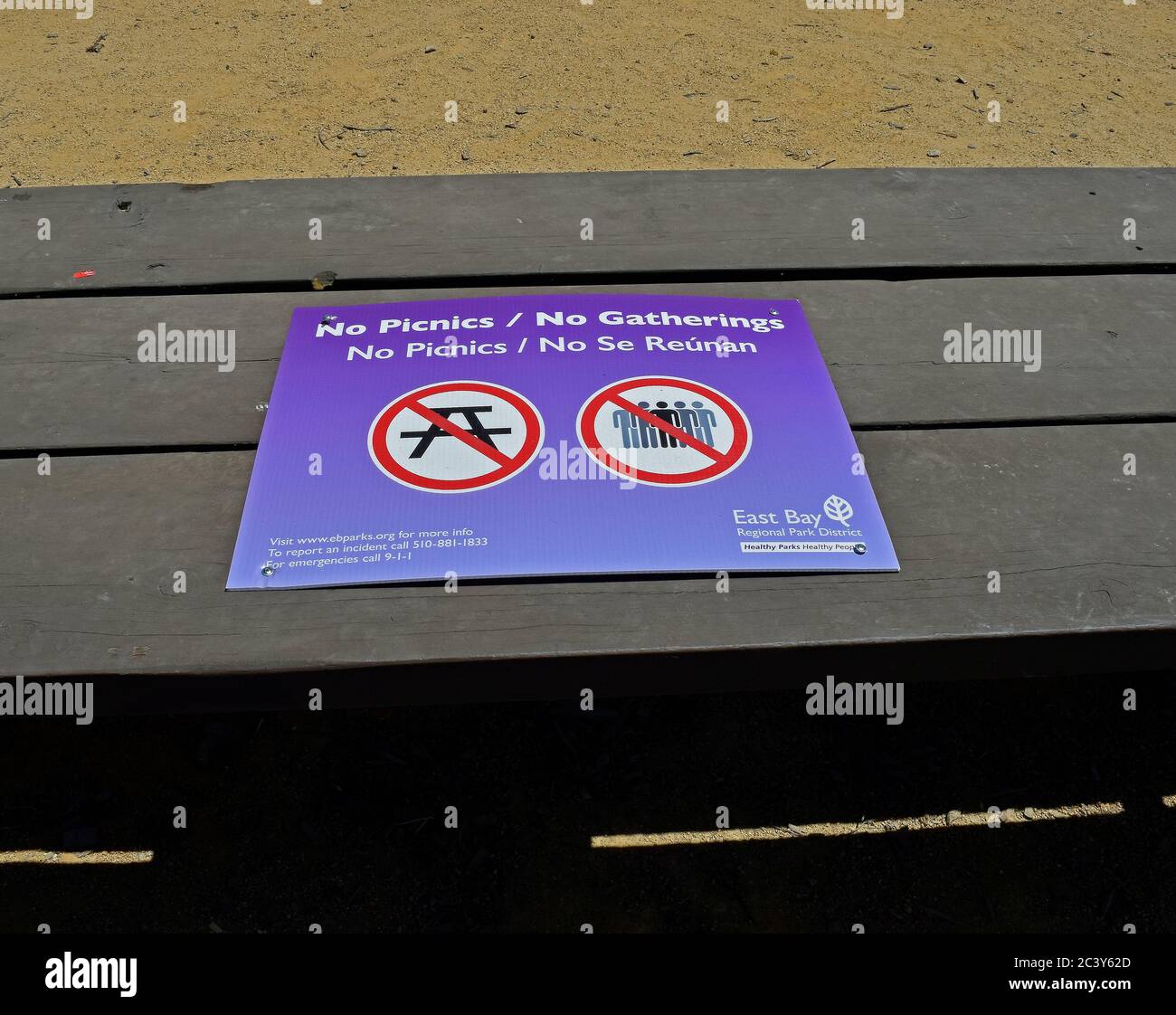 covid-19 virus pandemic sign on a picnic table prohibiting picnics and gatherings at the Alameda Creek Trail Stables Staging Area, California Stock Photo