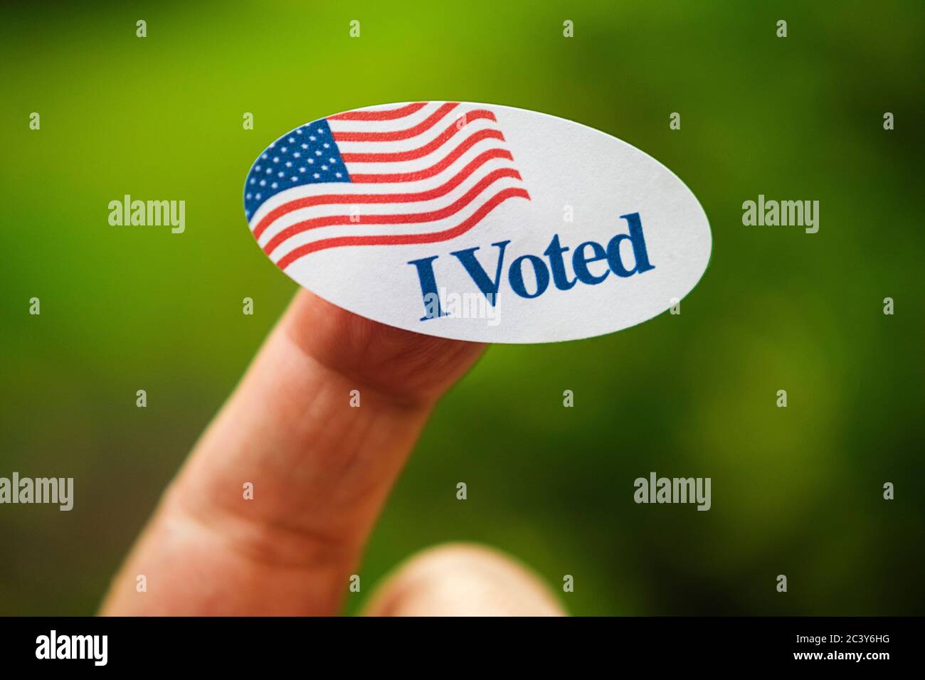 Close-up of I voted sticker on finger Stock Photo