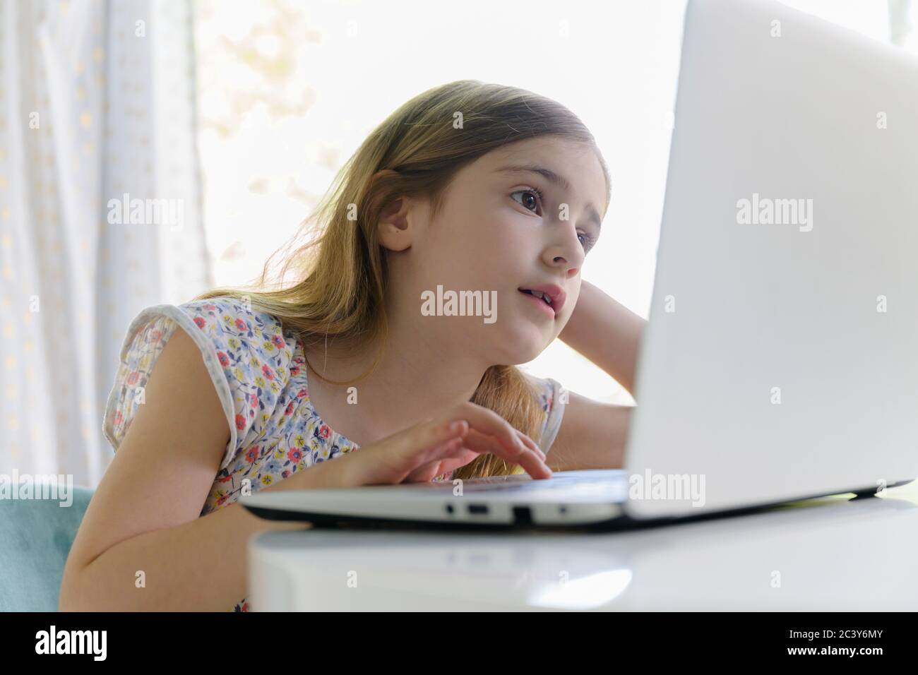 Girl (6-7) using laptop during remote learning Stock Photo