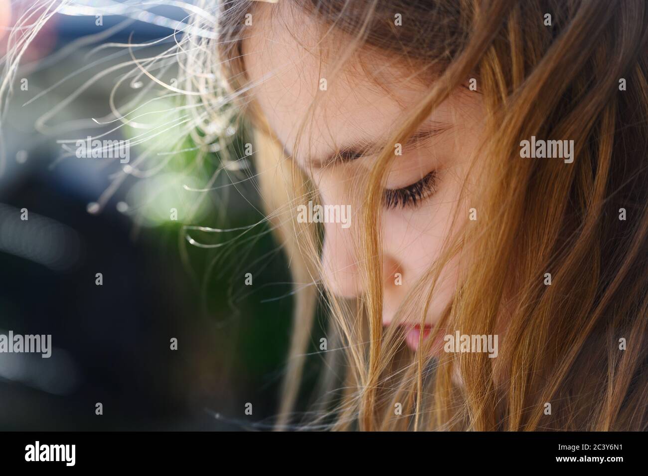 Close-up of girl (6-7) with wind blow hair Stock Photo