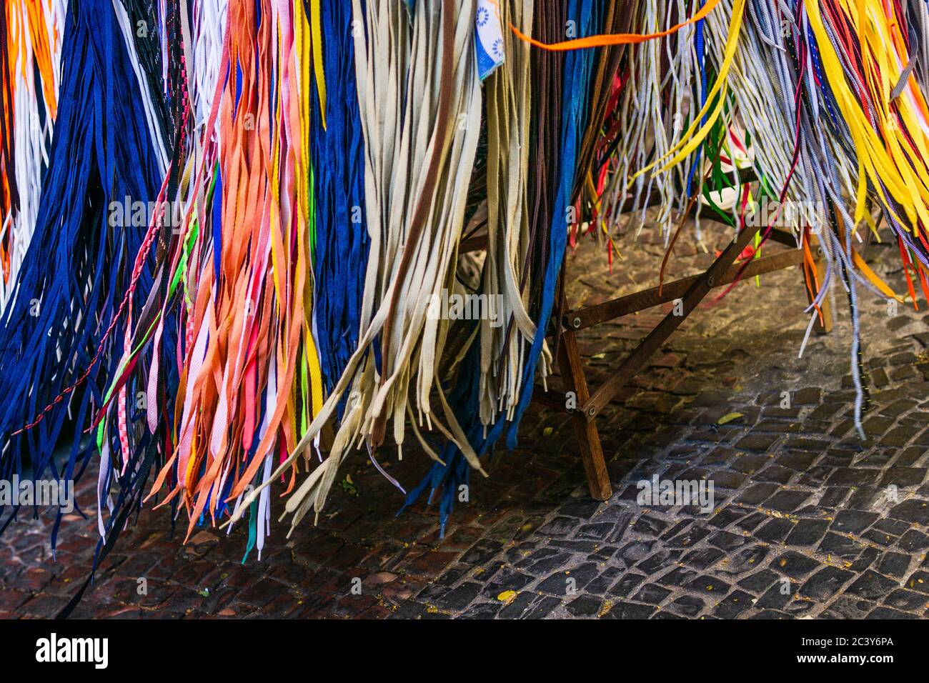 An array of colorful shoelaces hanging from a table on a street in Belo Horizonte, Brazil. Stock Photo