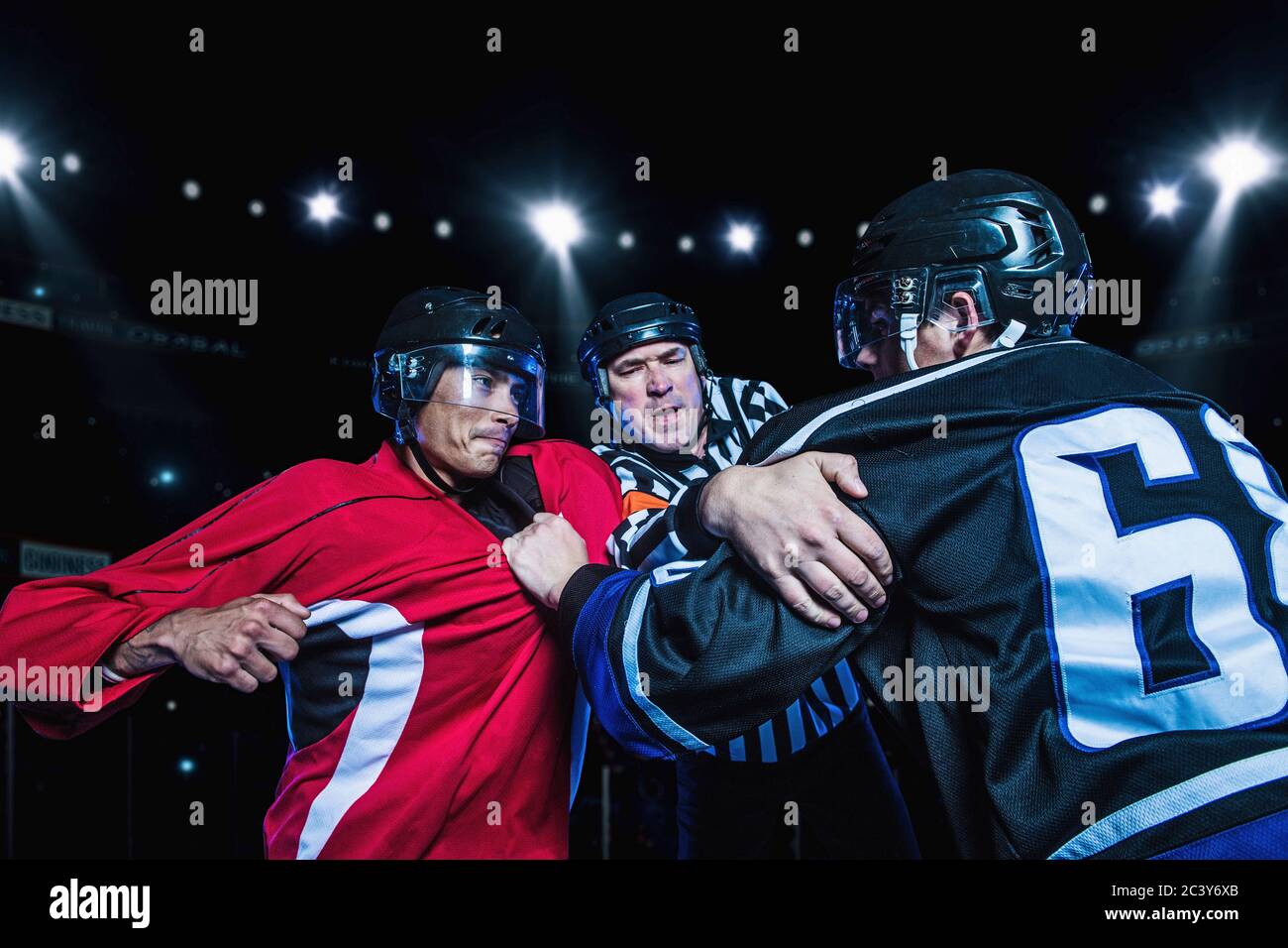 Referee separating fighting hockey players Stock Photo Alamy