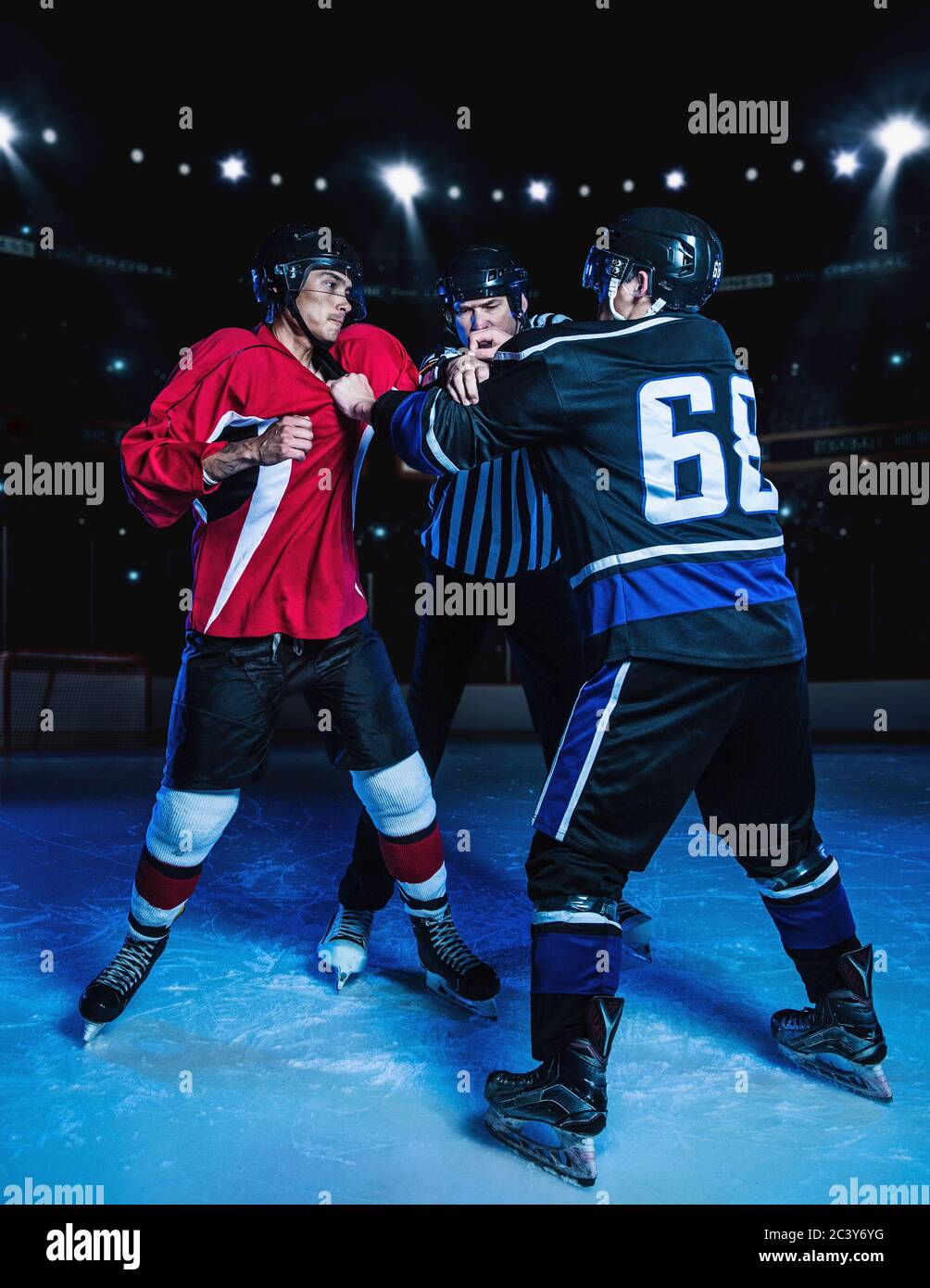 Referee separating fighting hockey players Stock Photo Alamy