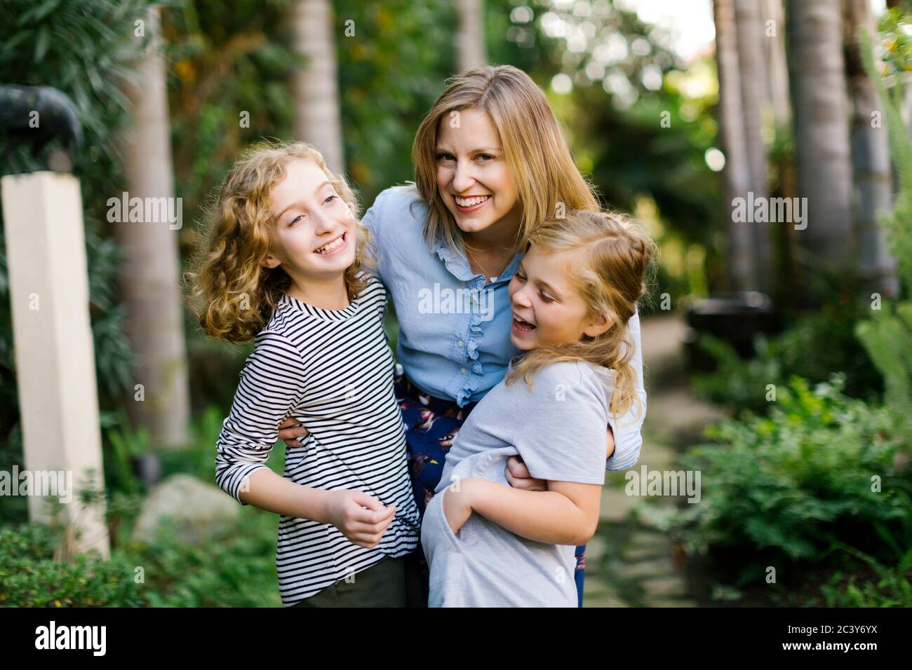 Portrait of mother with daughters (8-9, 12-13) Stock Photo