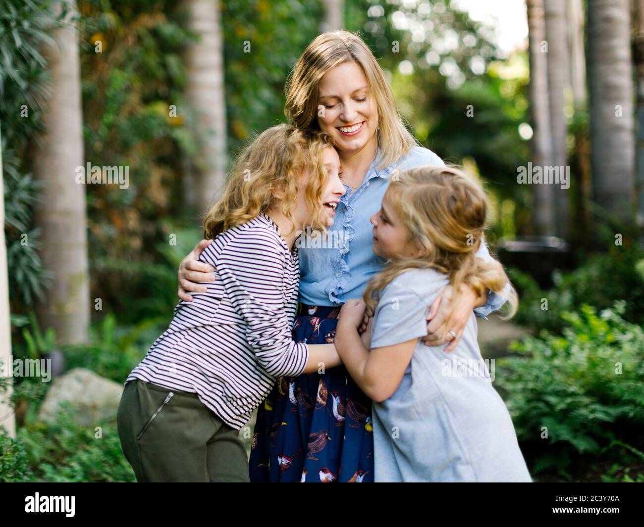 Portrait of mother with daughters (8-9, 12-13) Stock Photo