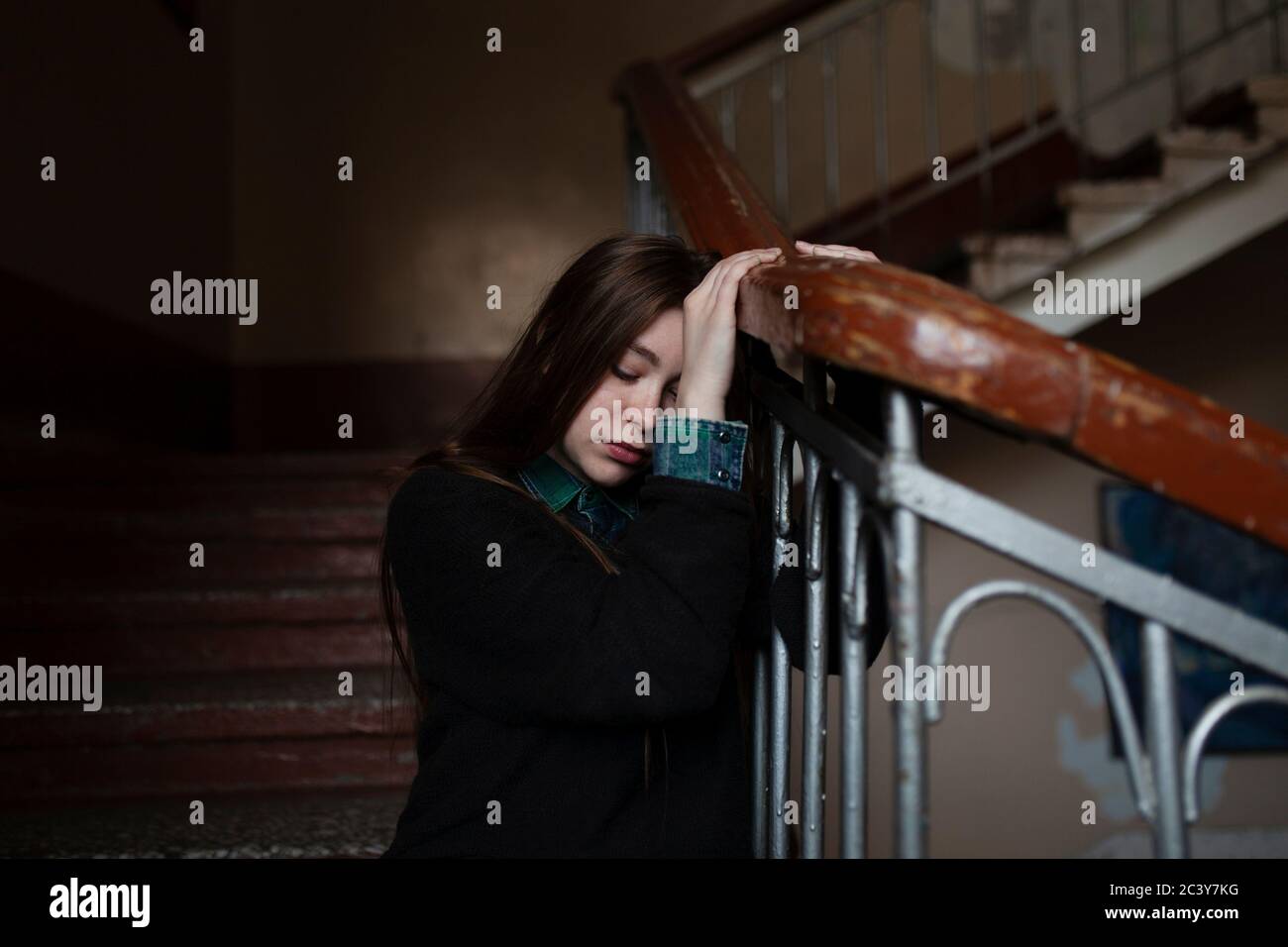 Young woman sitting on stairs Stock Photo