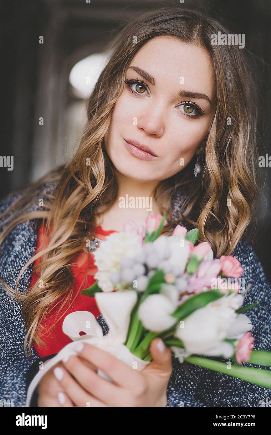 Portrait of bride holding bouquet of flowers Stock Photo
