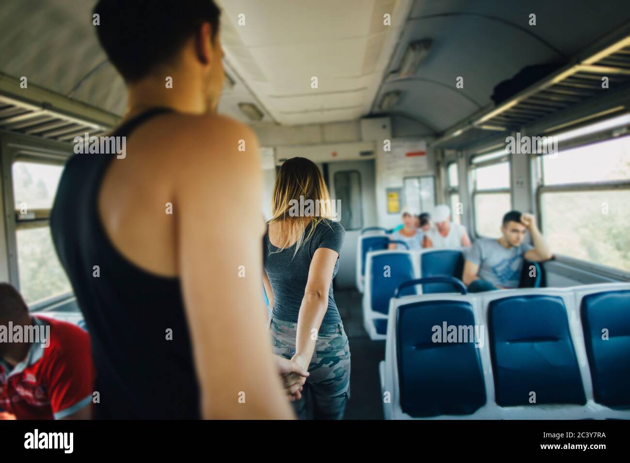 Young couple walking inside of train Stock Photo