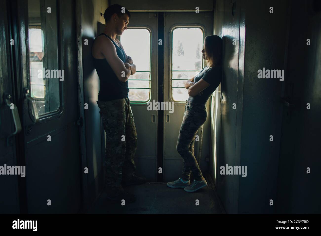 Young couple standing in train Stock Photo