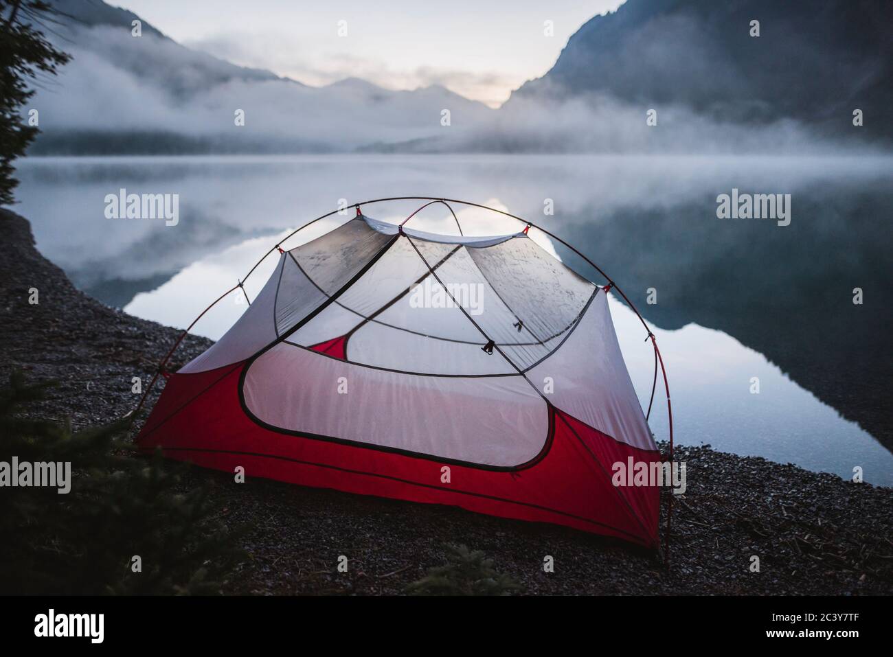 Austria, Plansee, Tent by lake Plansee at sunrise in fog Stock Photo