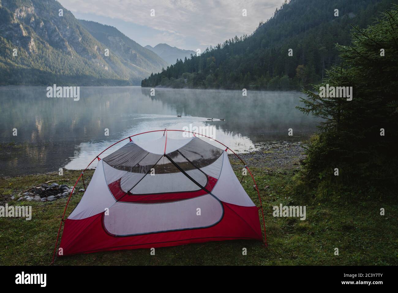 Austria, Plansee, Tent by lake Plansee in Austrian Alps at sunrise Stock Photo