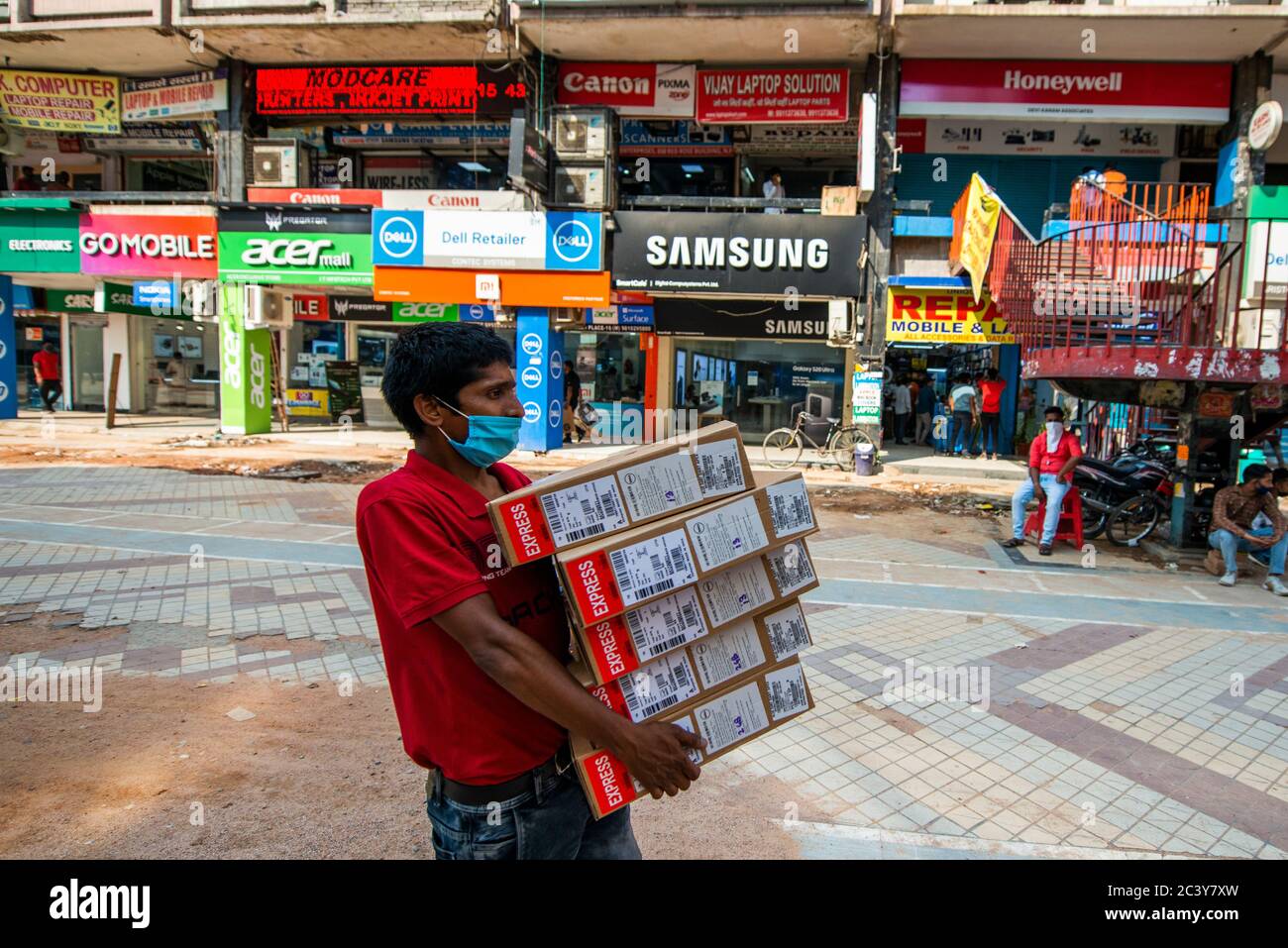 New Delhi, India. 22nd June, 2020. A worker carries a boxes of