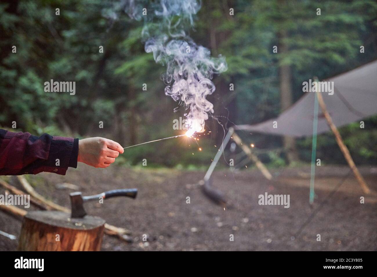 Orcas Island, Man holding sparkler at camping Stock Photo